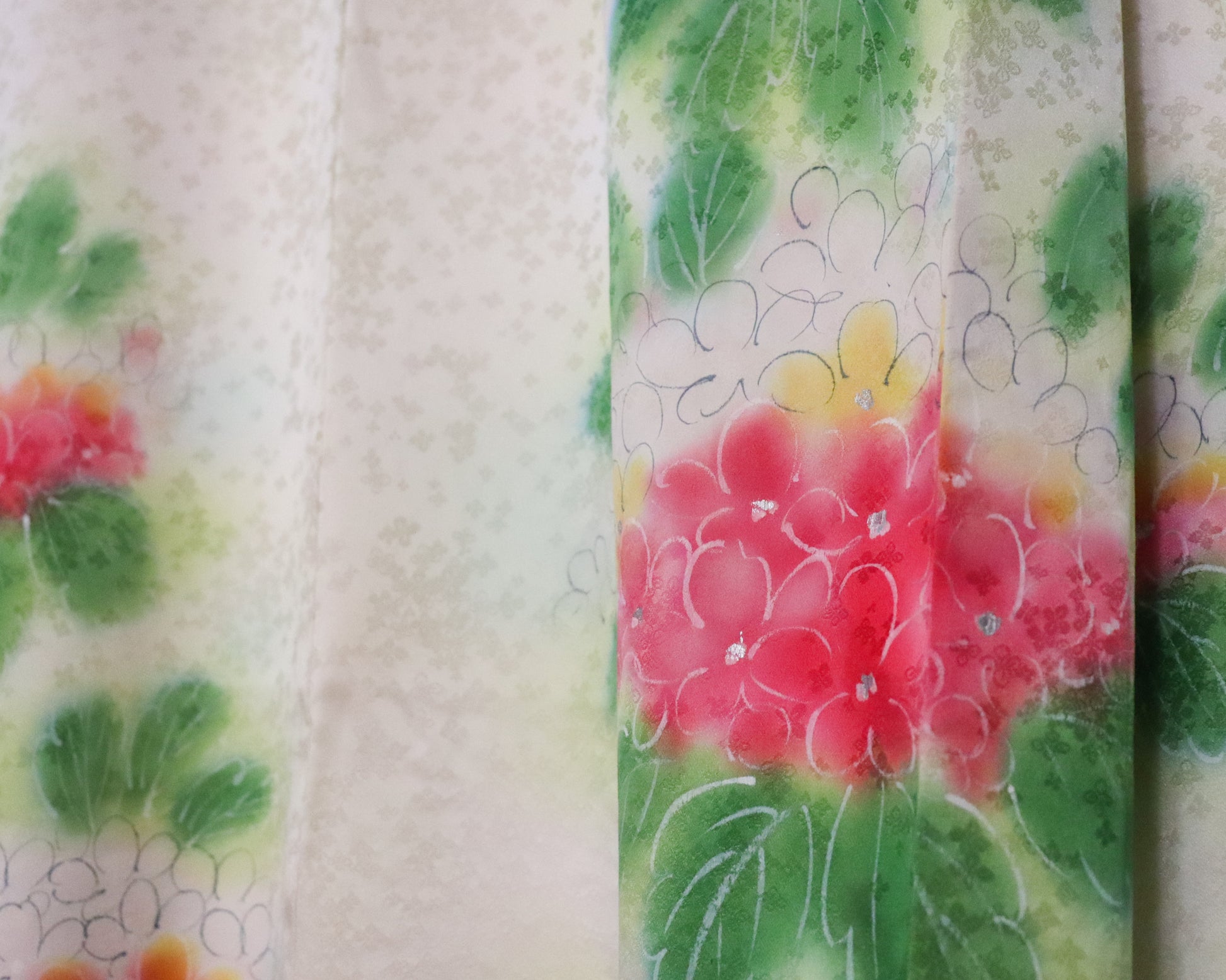 Vintage silk kimono in bright pastel green. Floral pattern. up close photo of the fabric.
