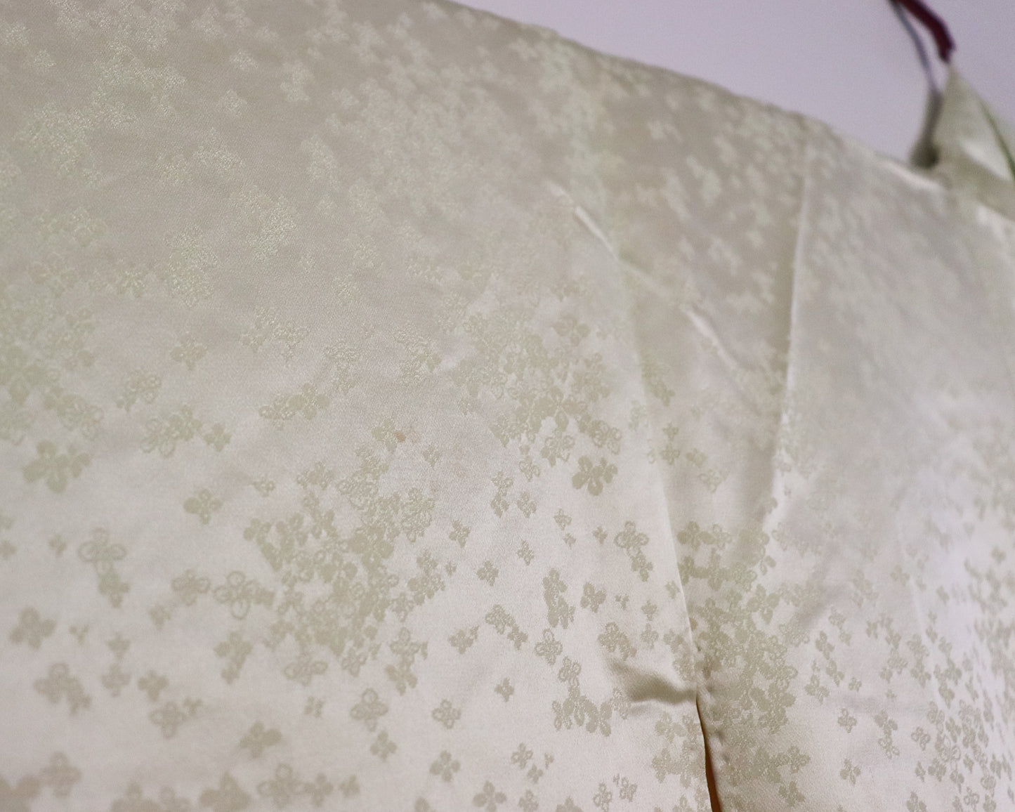 Vintage silk kimono in light pastel green with cute floral pattern. up close image of the fabric.