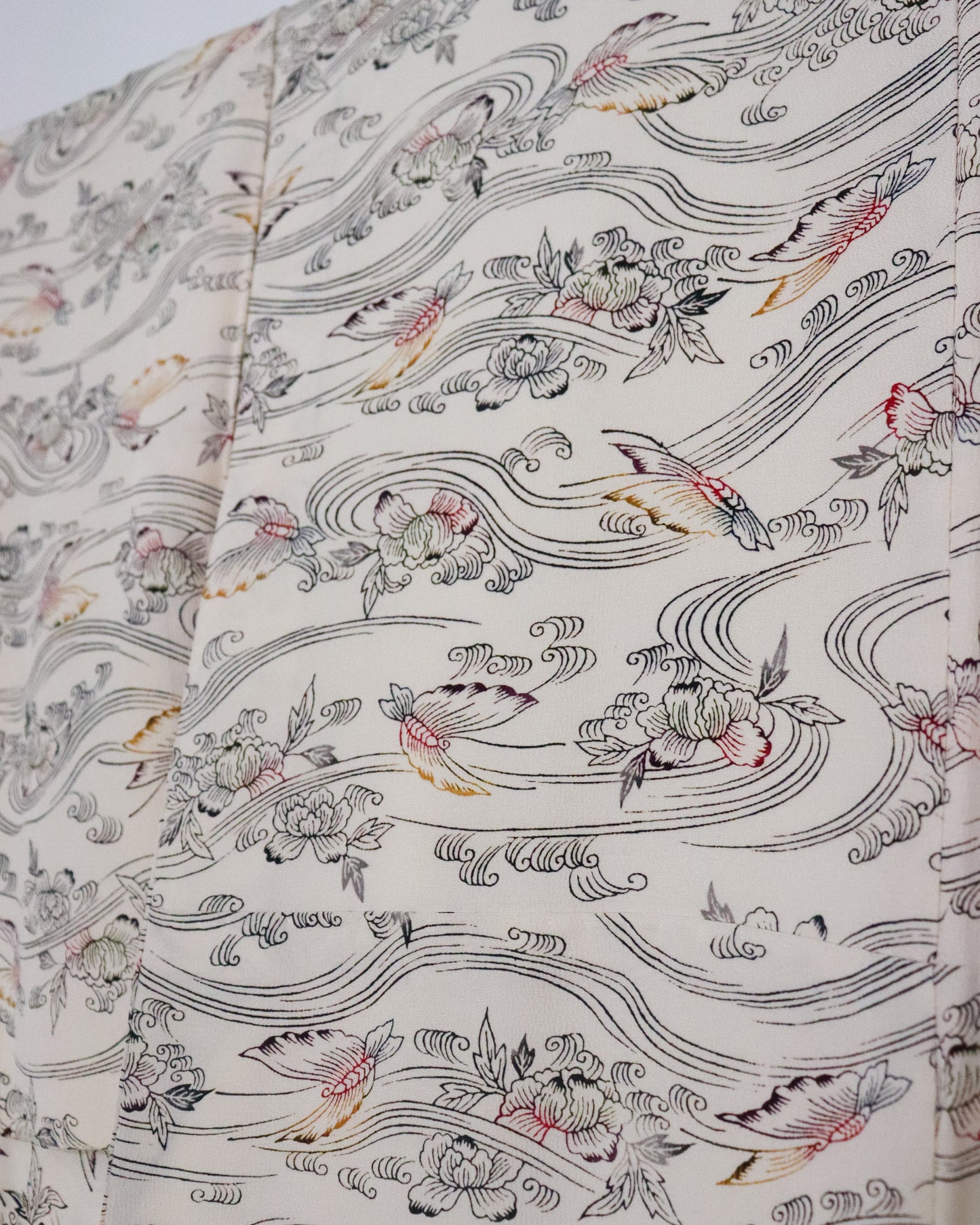 vintage silk kimono with retro nature pattern, wave and butterfly. creamy white. close up image of the vintage silk kimono fabric.