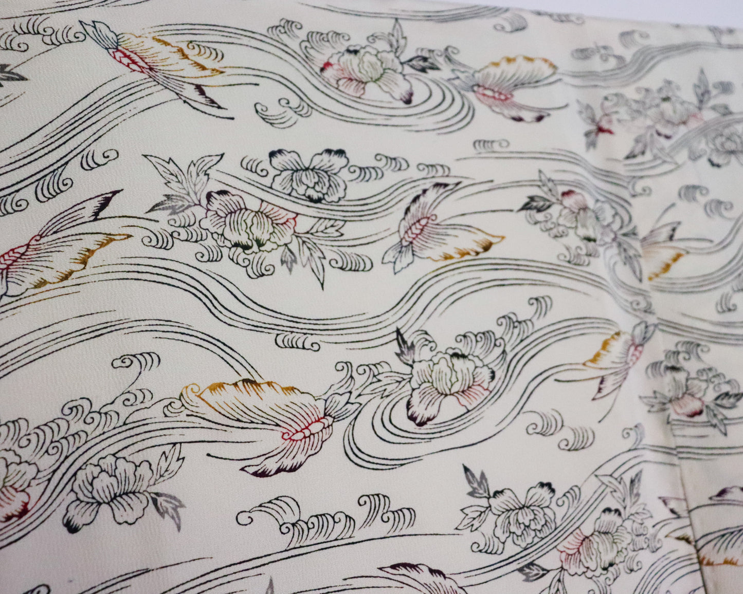 vintage silk kimono with retro nature pattern, wave and butterfly. creamy white. close up image of the fabric.