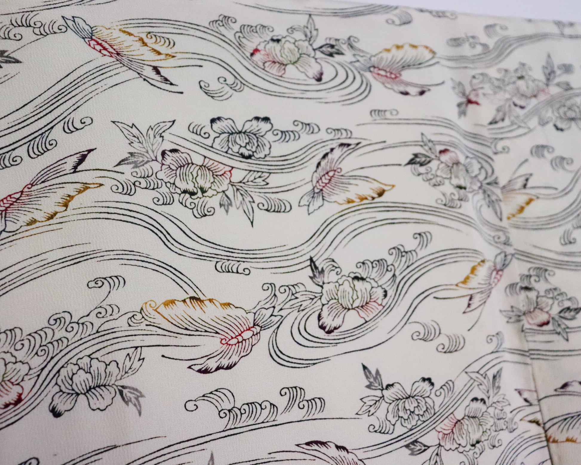 vintage silk kimono with retro nature pattern, wave and butterfly. creamy white. close up image of the fabric.