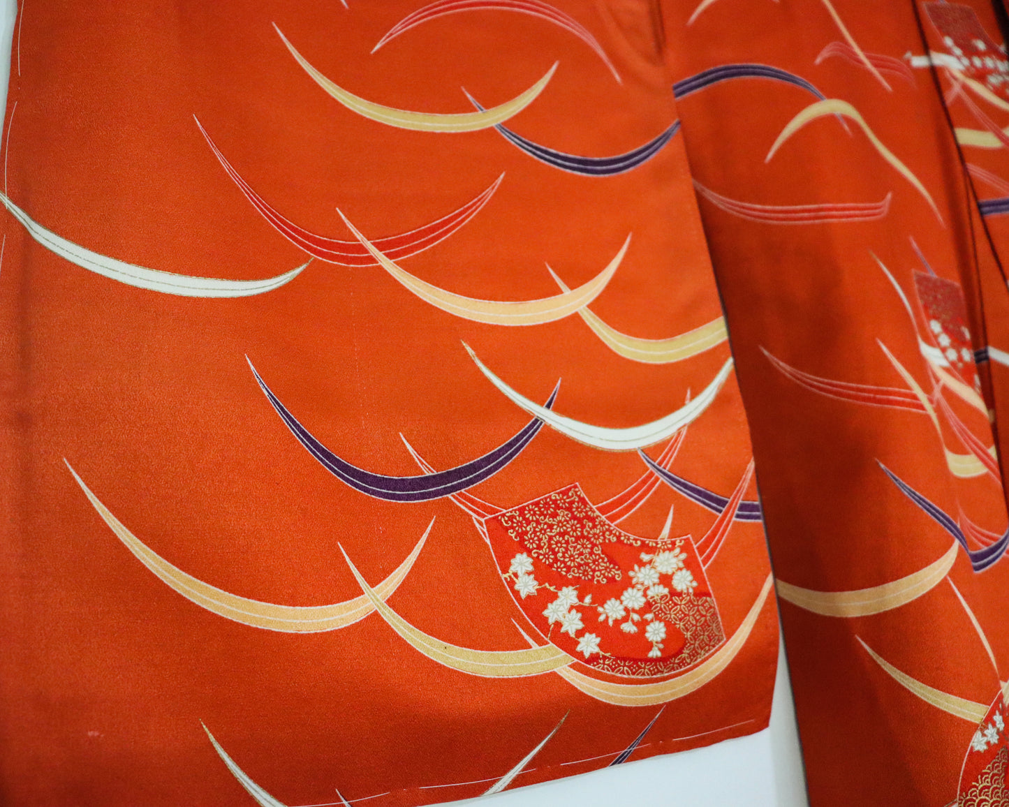 pre-loved kimono in vivid red with nature motif pattern and floral Japanese fans.