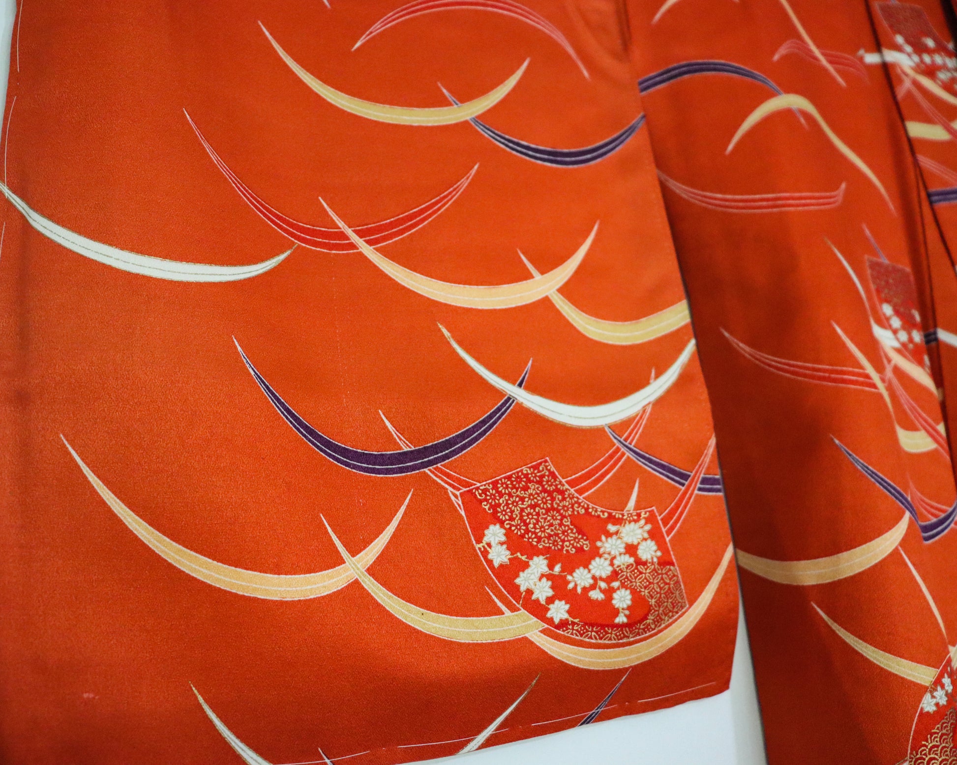 pre-loved kimono in vivid red with nature motif pattern and floral Japanese fans.