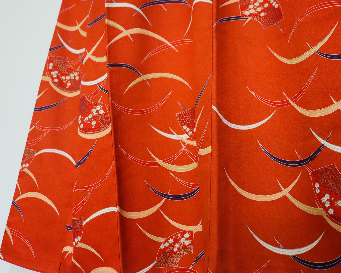 pre-loved kimono in vivid red with nature motif pattern and floral Japanese fans.