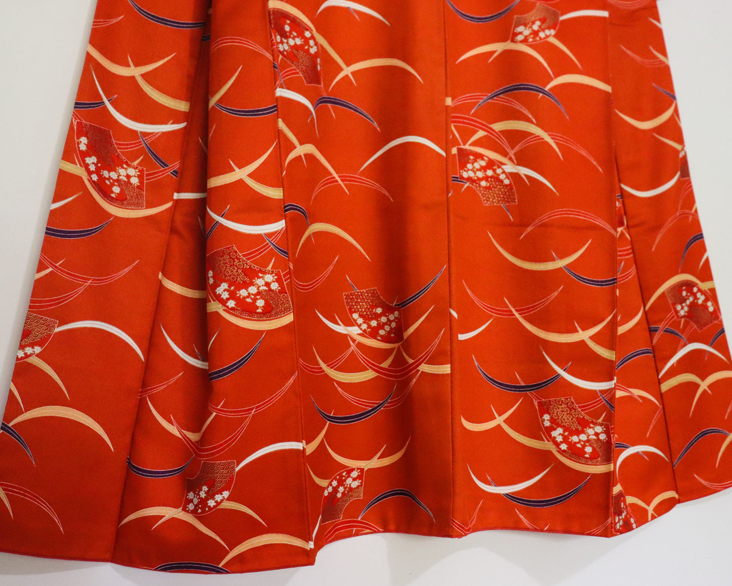 pre-loved kimono in vivid red with nature motif pattern and floral Japanese fans.