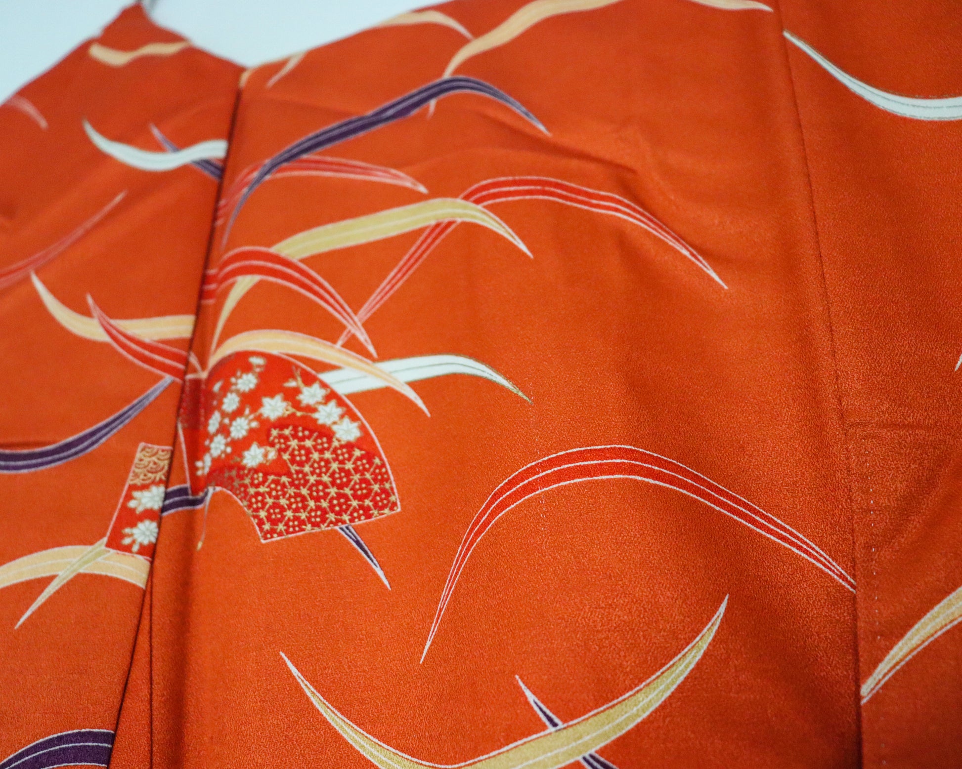 pre-loved kimono in vivid red with nature motif pattern and floral Japanese fans.