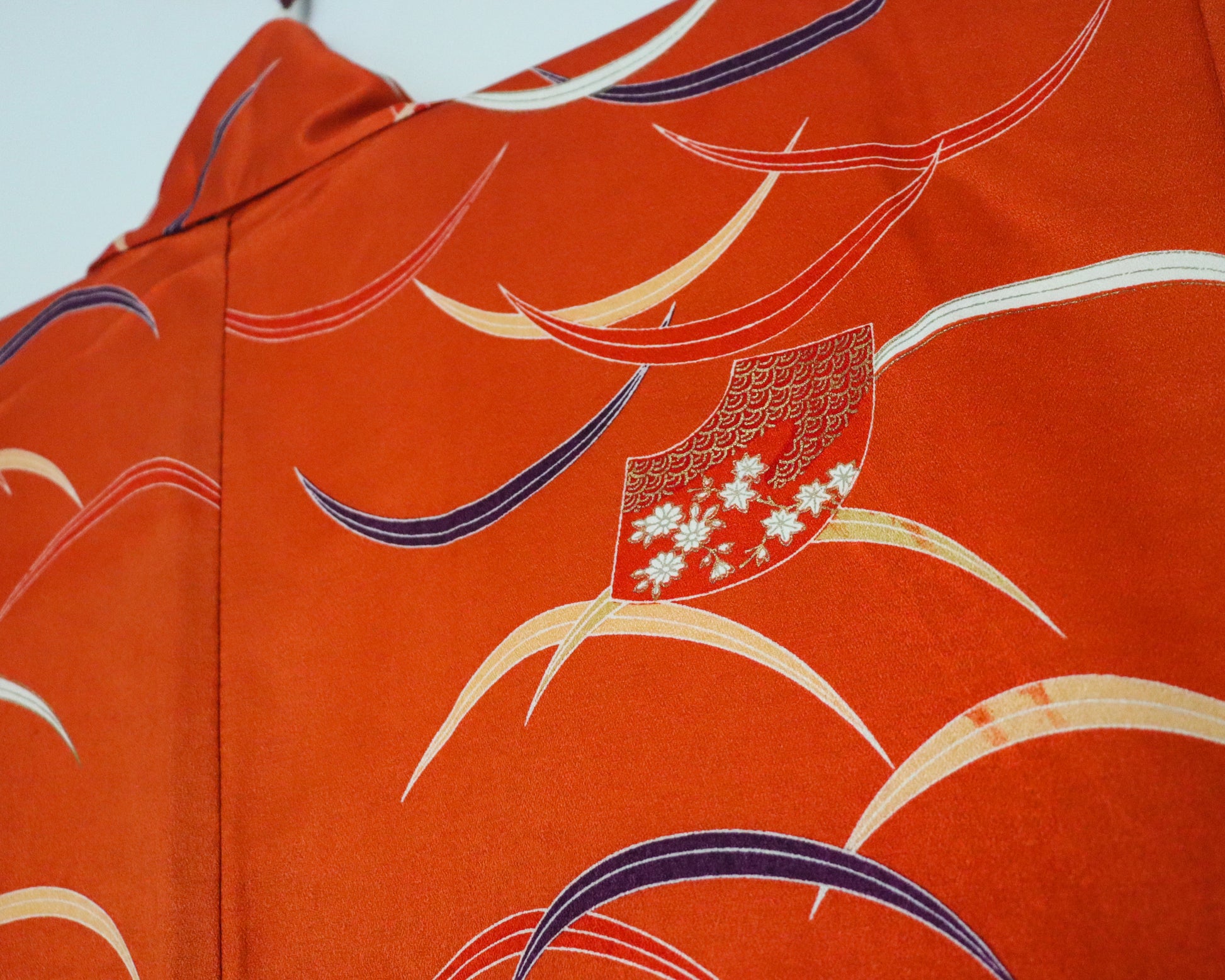 pre-loved kimono in vivid red with nature motif pattern and floral Japanese fans.
