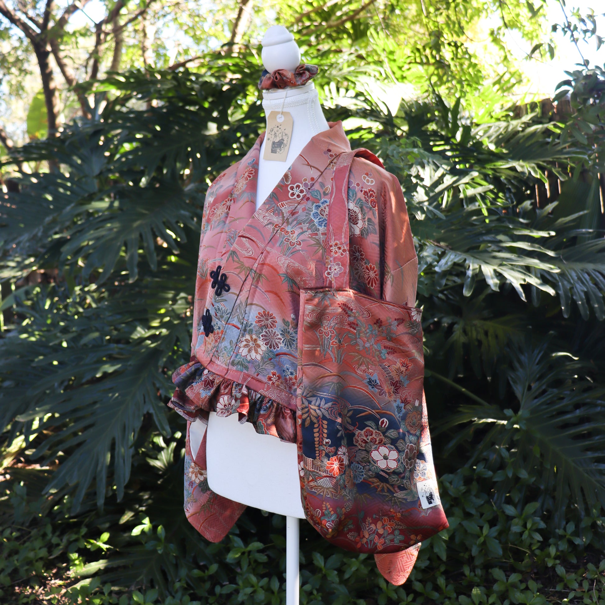 Cropped kimono jacket made from a vintage kimono. The jacket features ruffled hem and frog closures, also comes with matching tote bag and scrunchie.