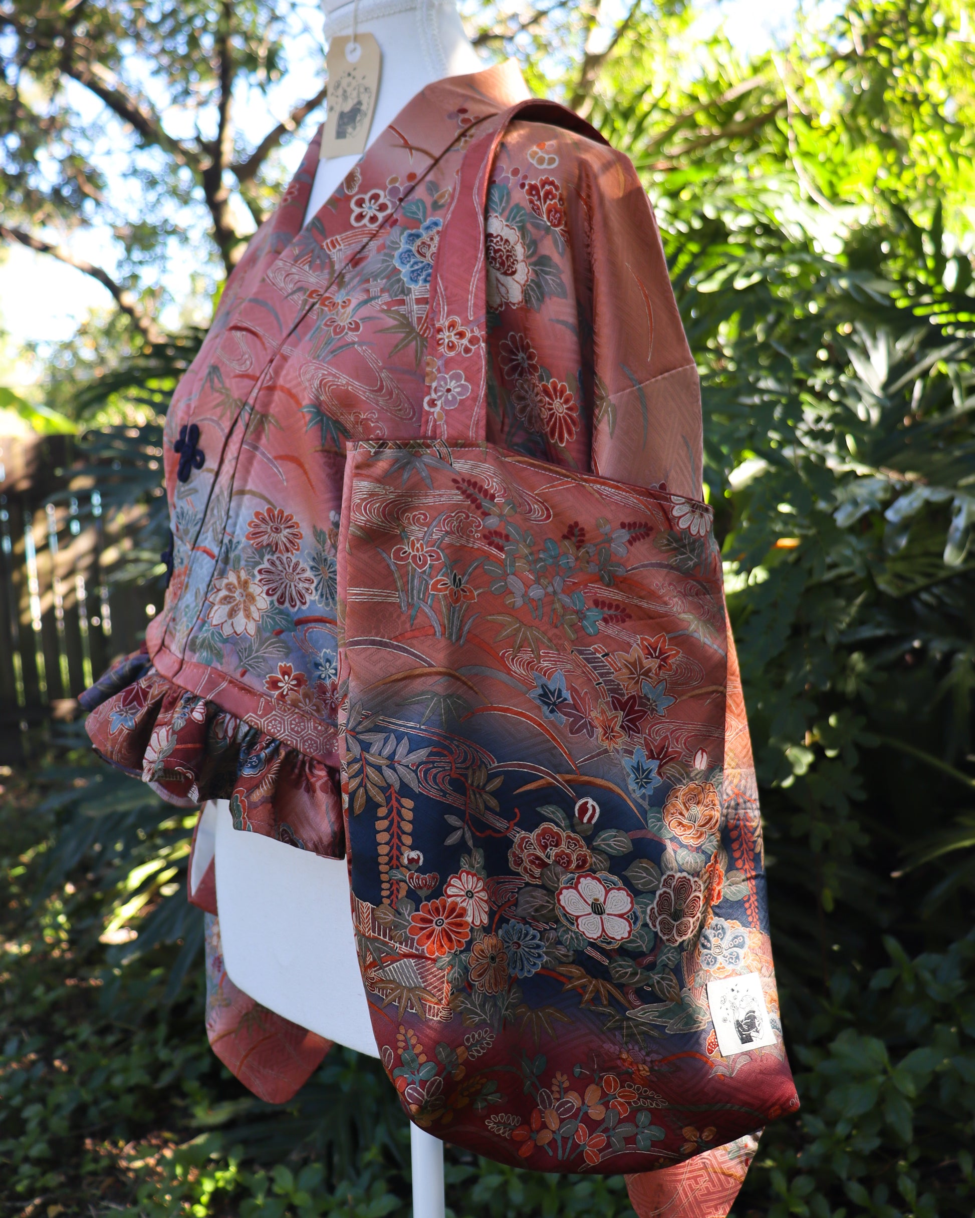 Cropped kimono jacket made from a vintage kimono. The jacket features ruffled hem and frog closures, also comes with matching tote bag and scrunchie.
