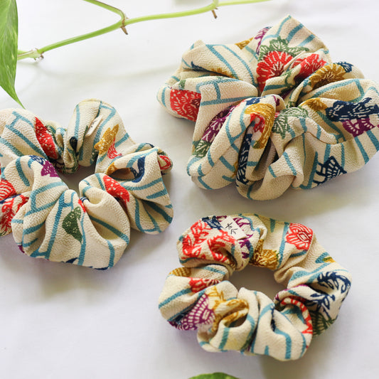 Colorful patterned scrunchies on a white background