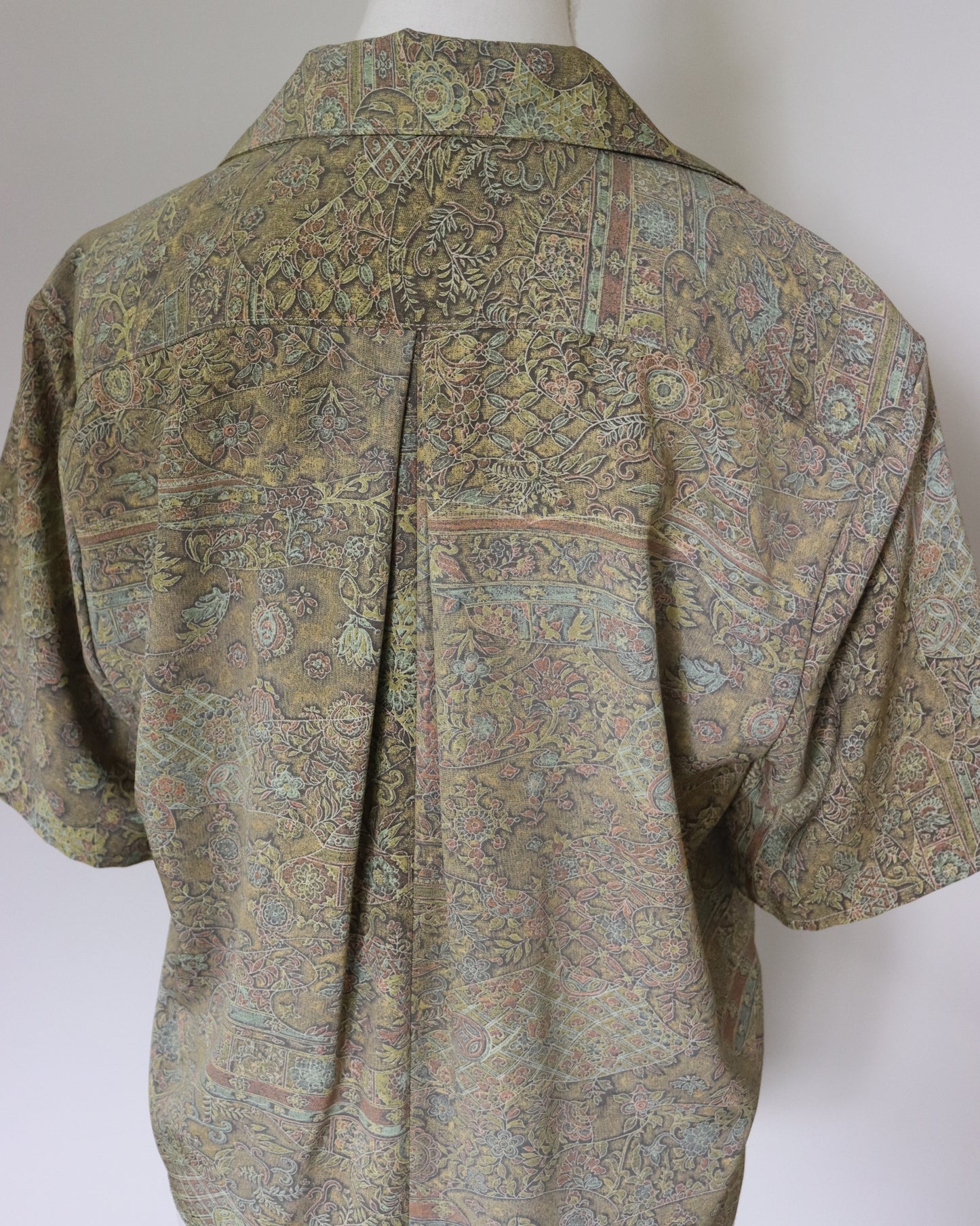 Short-sleeve shirt with a pattern on a mannequin against a white background