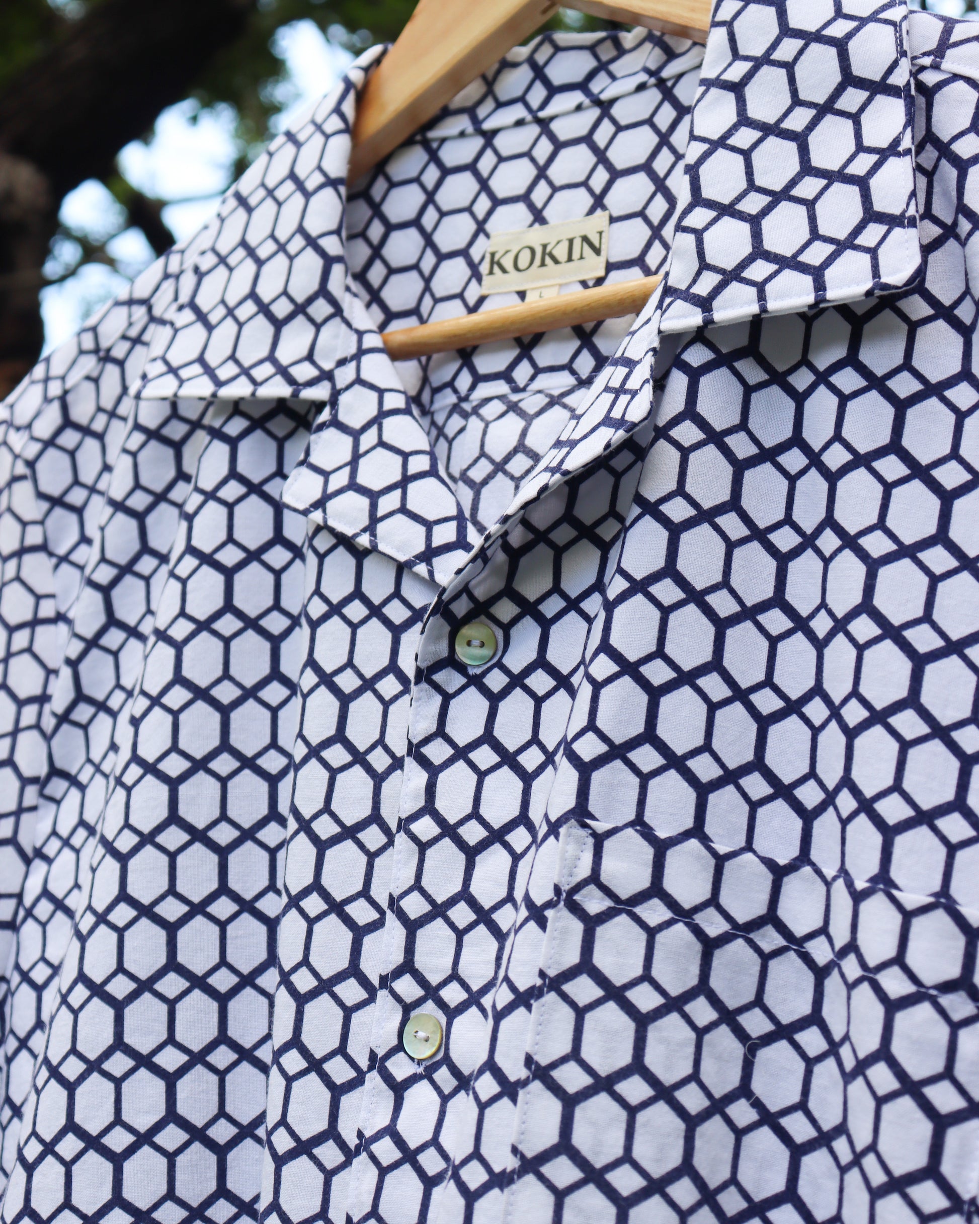 Men's summer shirt made from cotton kimono (yukata). Casual short sleeve shirt. Close up of the shell buttons.