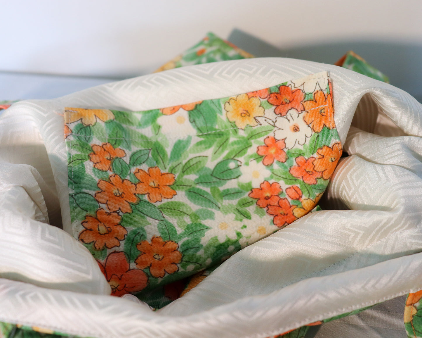 Drawstring tote bag made from silk kimono fabric. Vivid floral pattern. Inside pocket.
