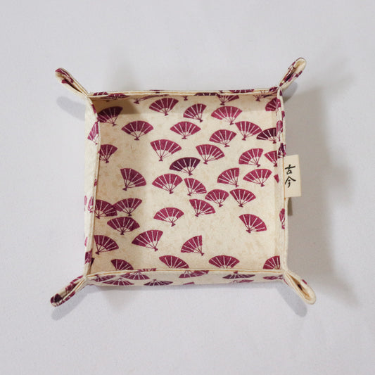 Fabric tray with purple Japanese fan pattern in white background.