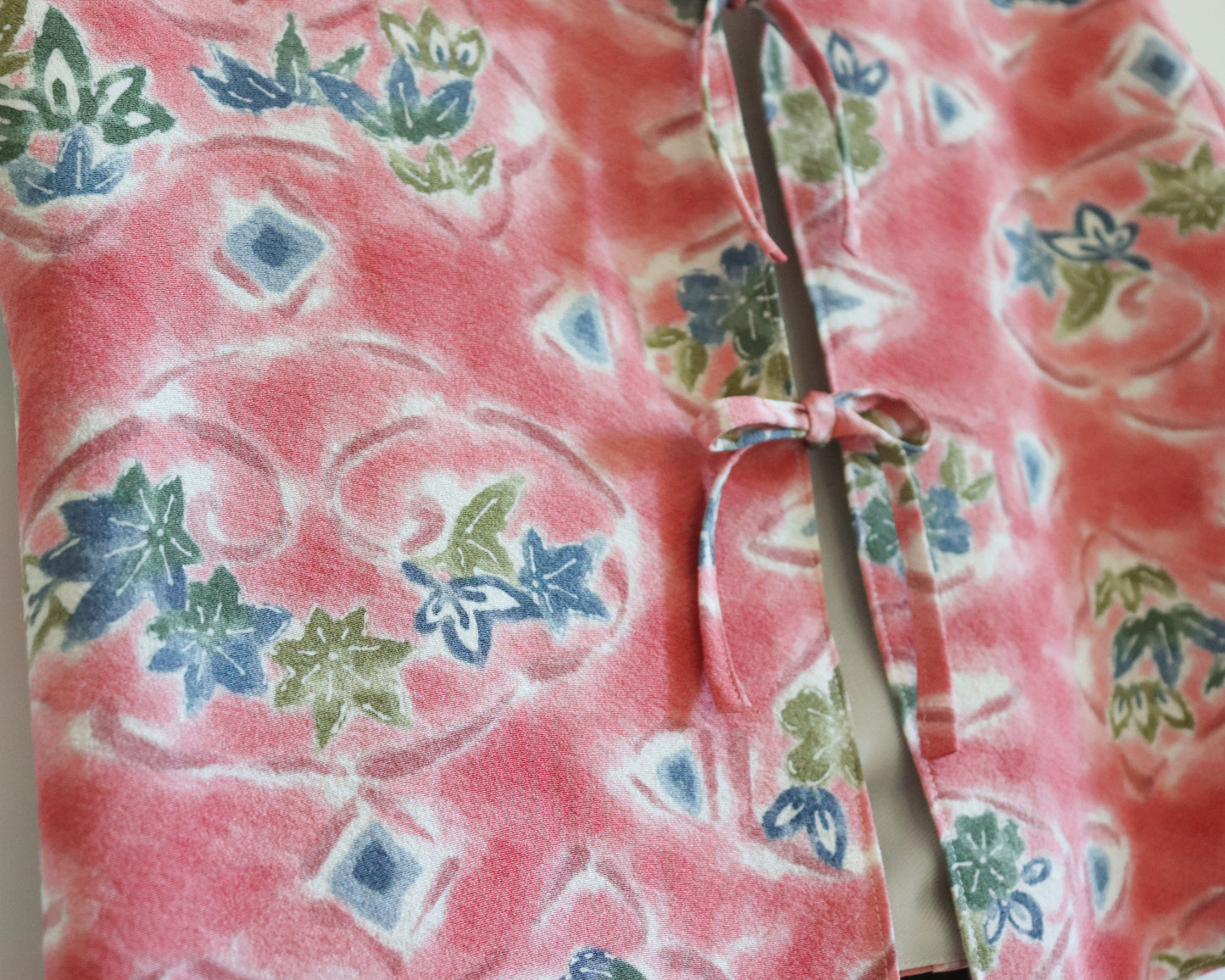 Women's front tie top made from pre-loved silk kimono. Slow fashion. Upcycling. Fully lined with deadstock fabric. Close up image of the silk kimono fabric with the pattern of nature.