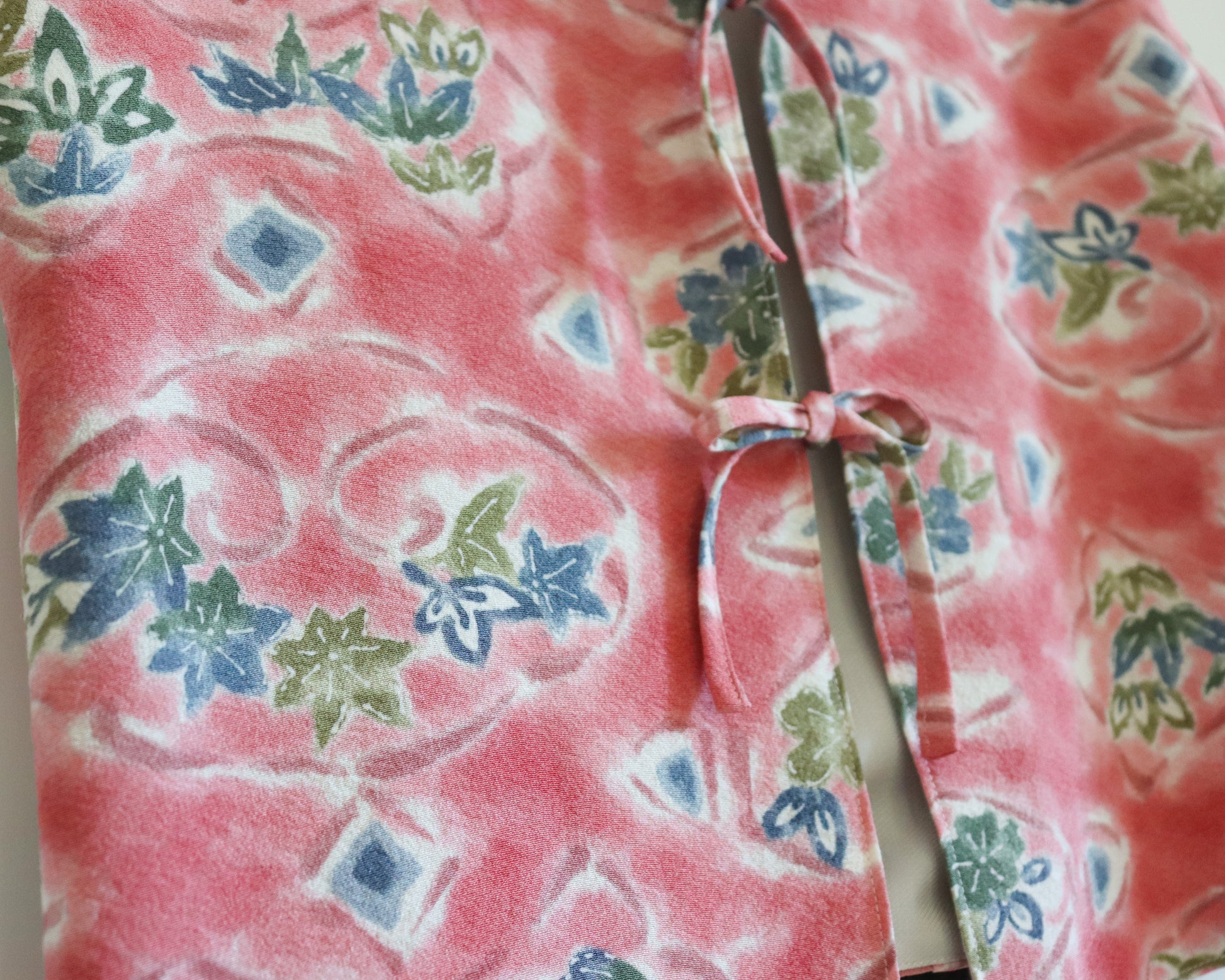 Women's front tie top made from pre-loved silk kimono. Slow fashion. Upcycling. Fully lined with deadstock fabric. Close up image of the silk kimono fabric with the pattern of nature.