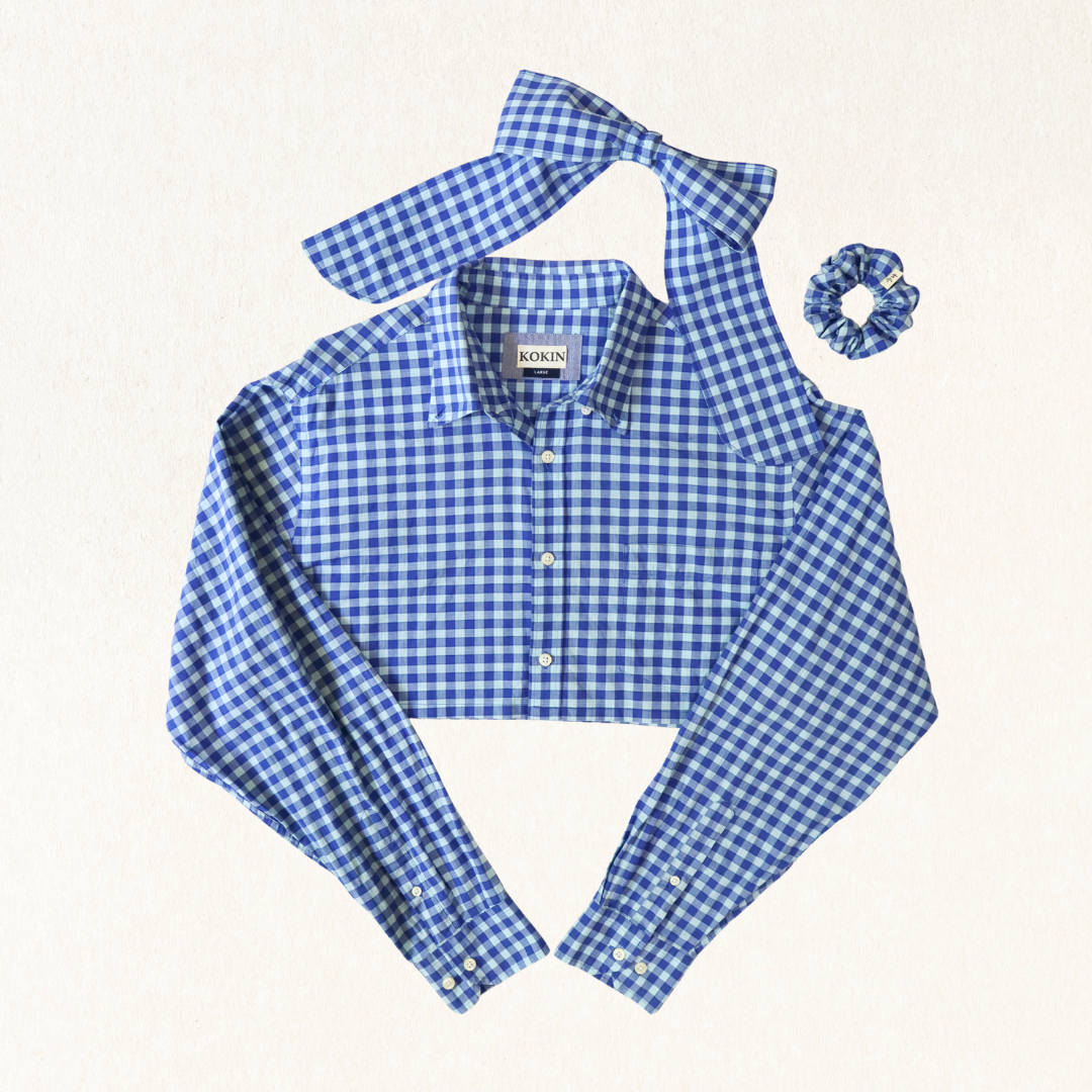 Blue gingham shirt with matching bow tie and scrunchie on a white background