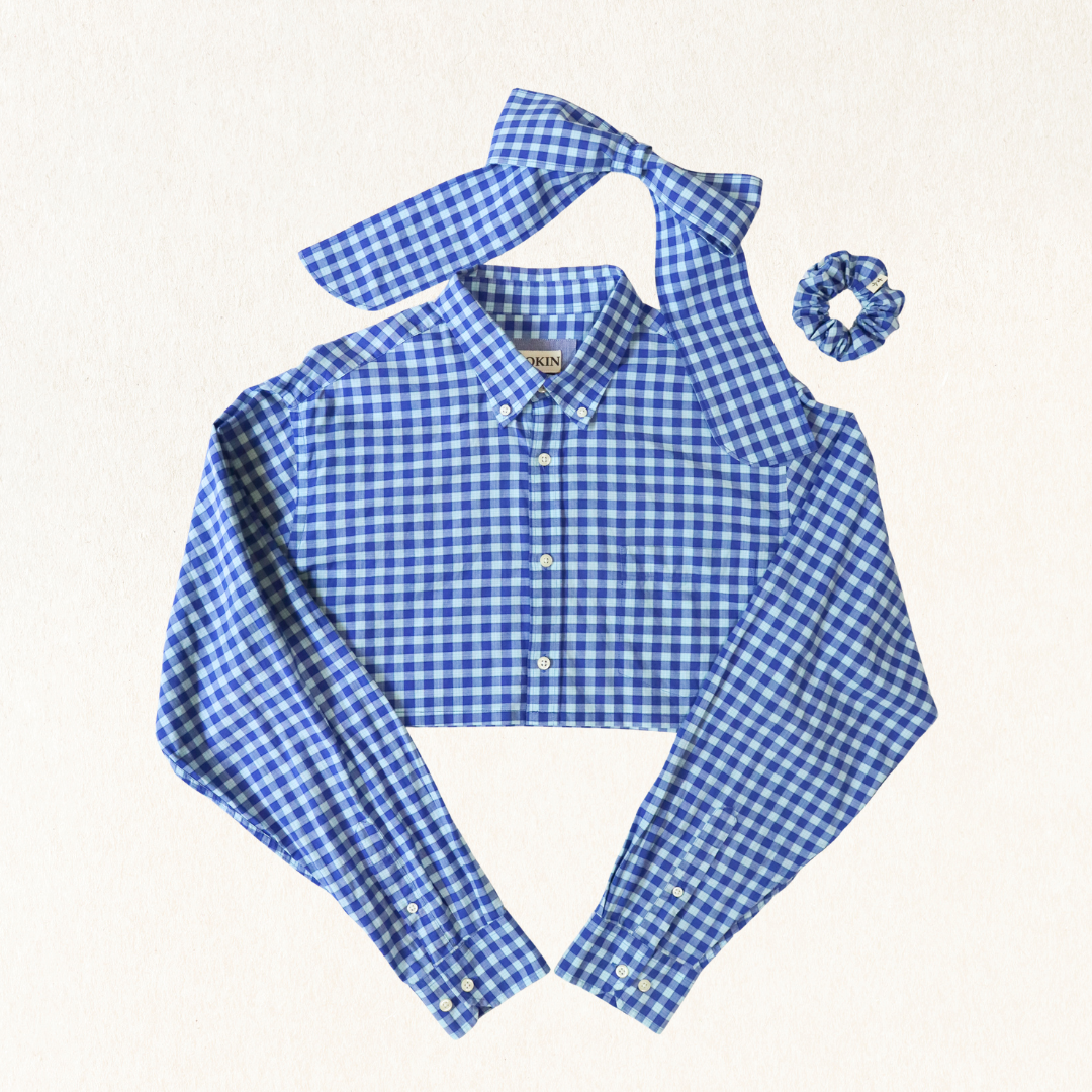 Blue and white checkered shirt with matching bow tie and scrunchie on a light gray background