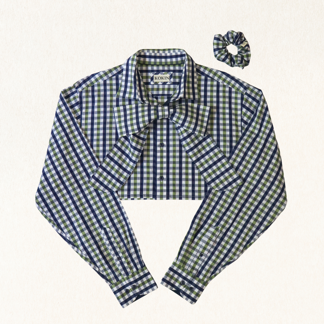 Green and blue checkered blouse with a matching scrunchie on a white background