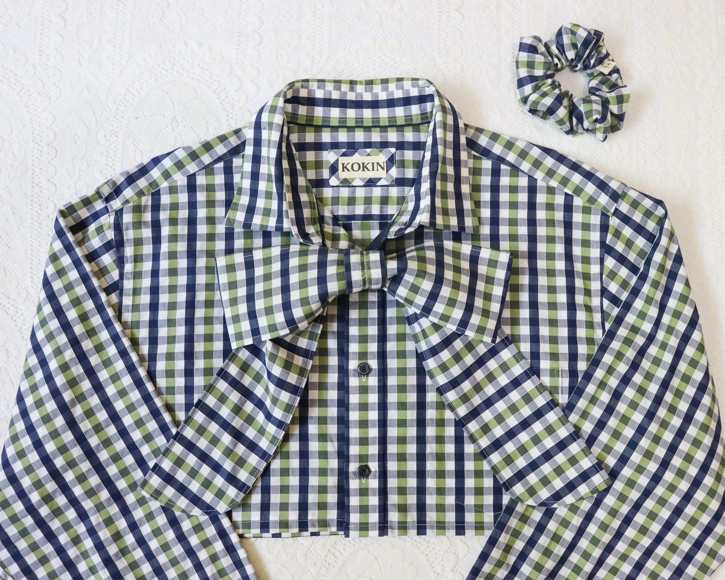 Green and blue checkered shirt with 'KOKIN' label on a white background