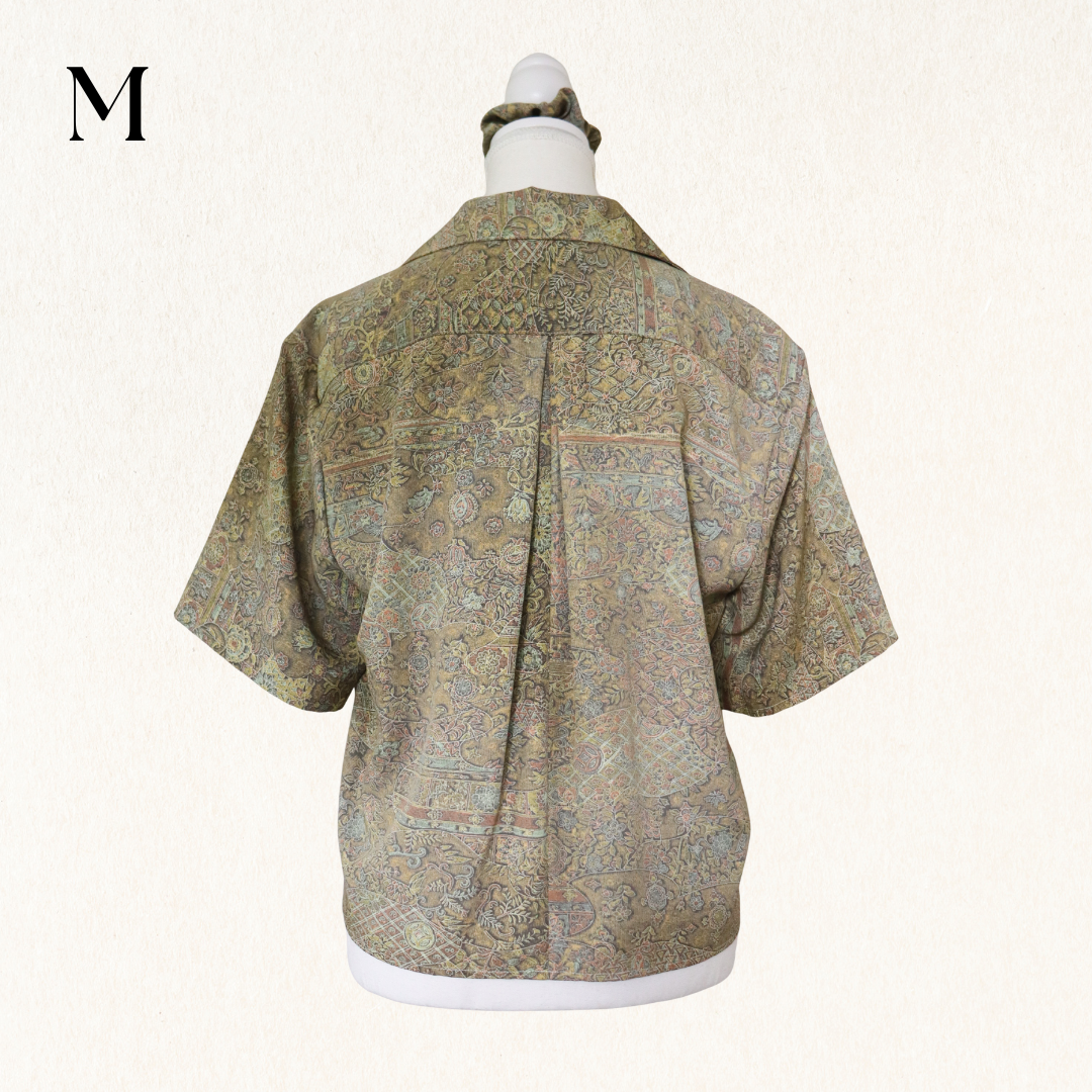 Mannequin wearing a patterned shirt on a white background