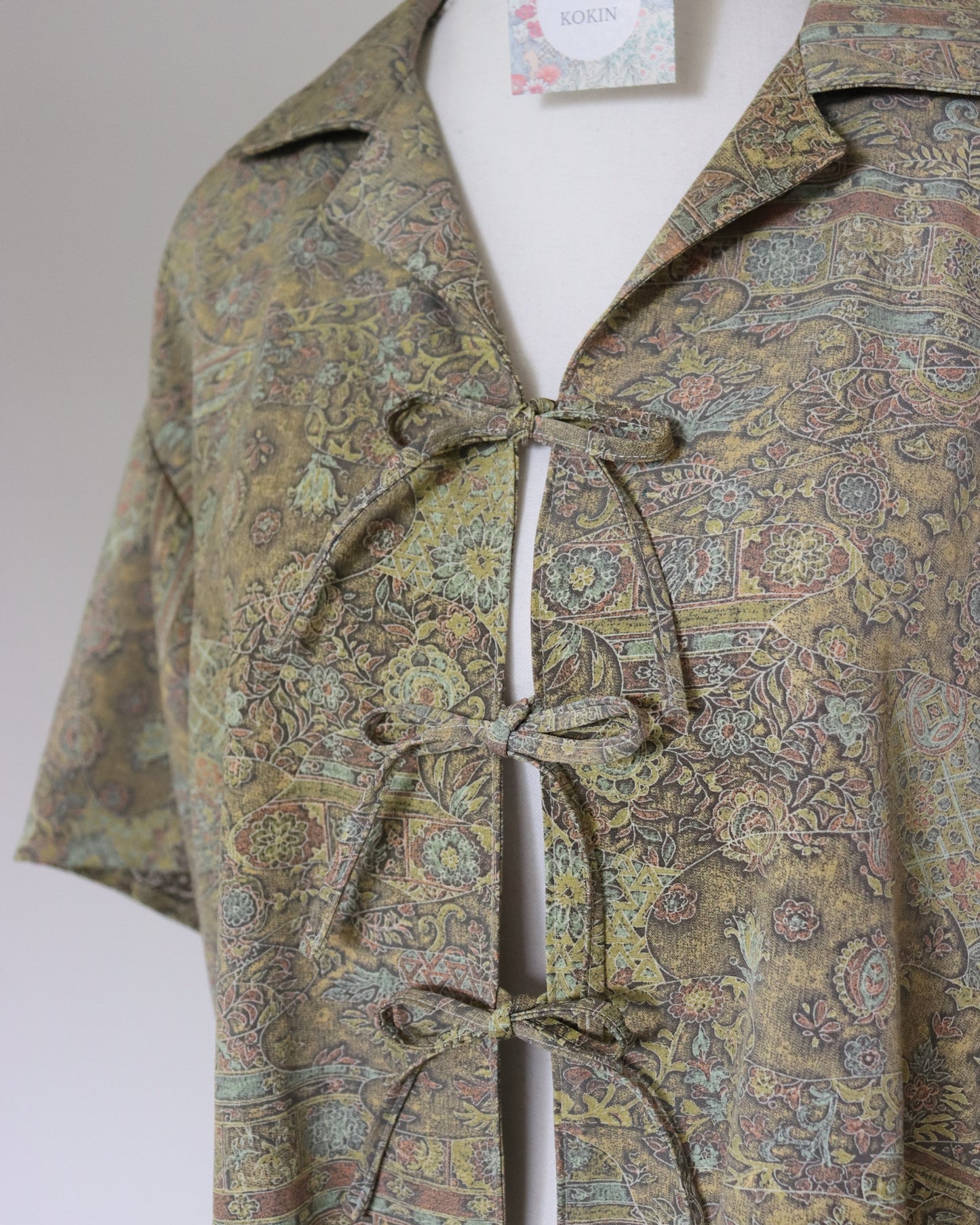 Patterned shirt on a mannequin with a plain background