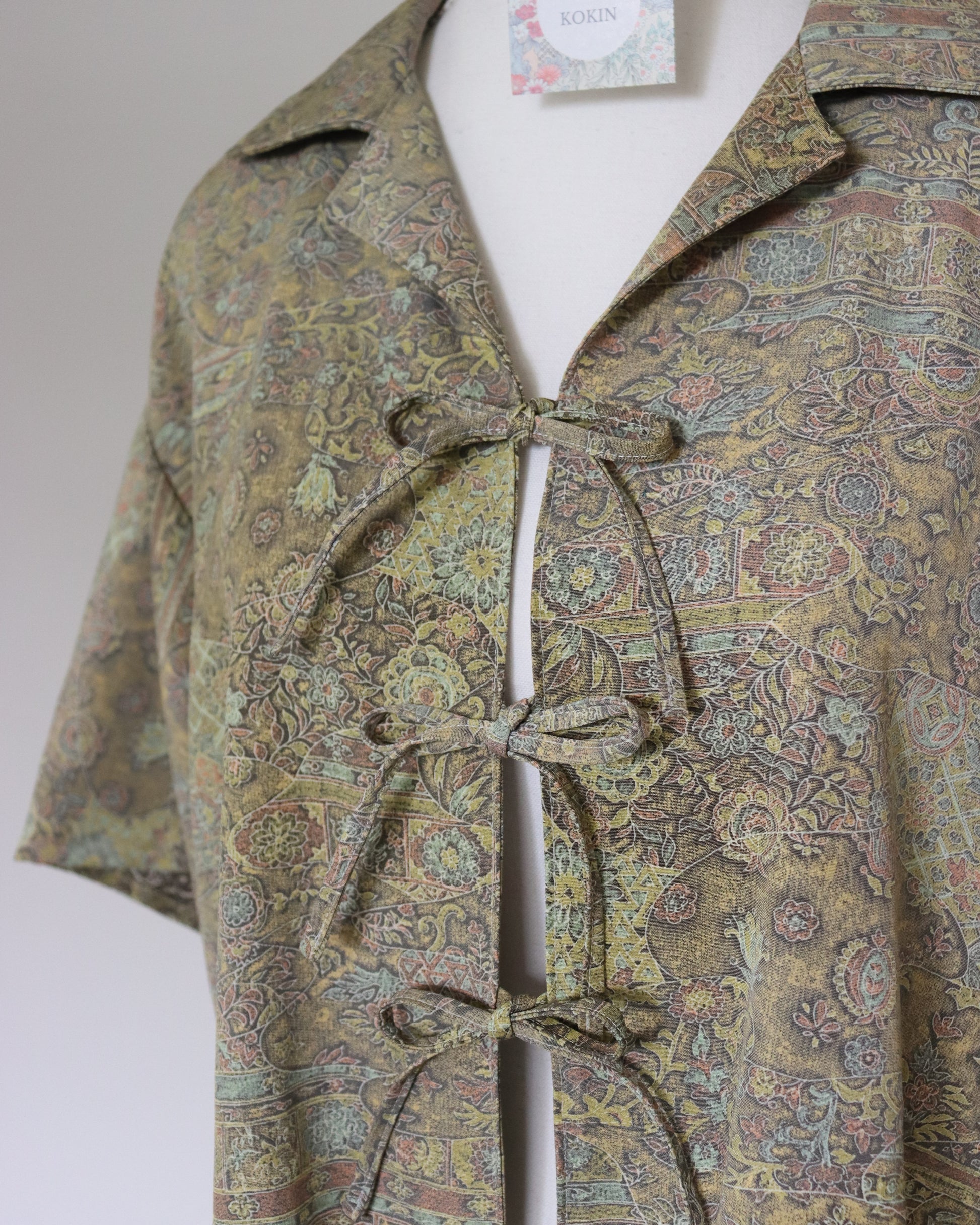 Patterned shirt on a mannequin with a plain background