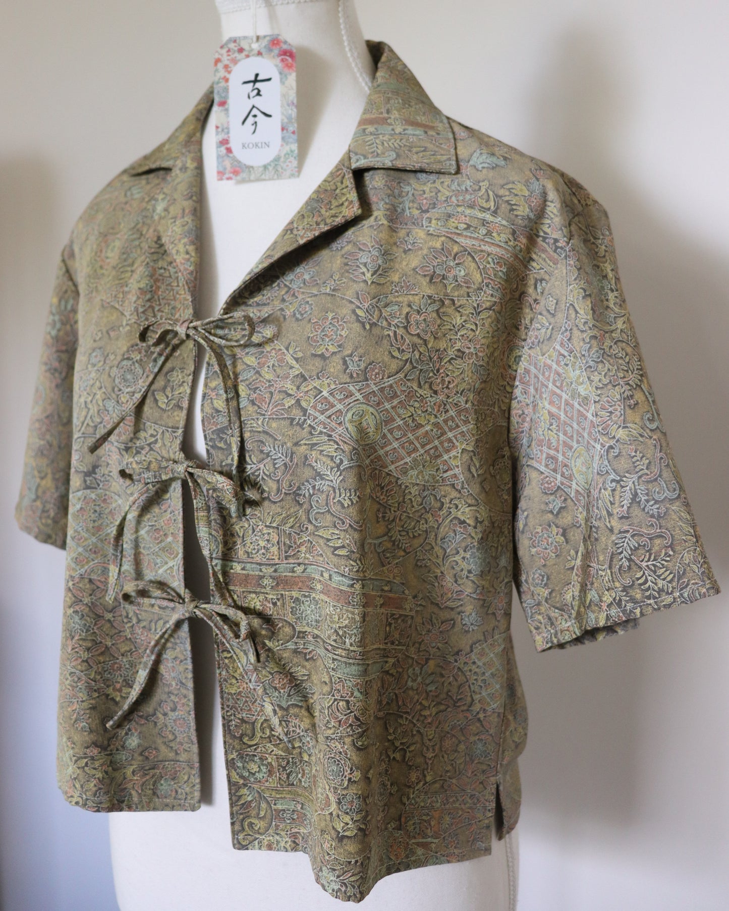 Patterned shirt on a mannequin with a plain background