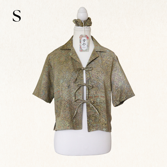 Short-sleeve patterned shirt on a mannequin with a white background