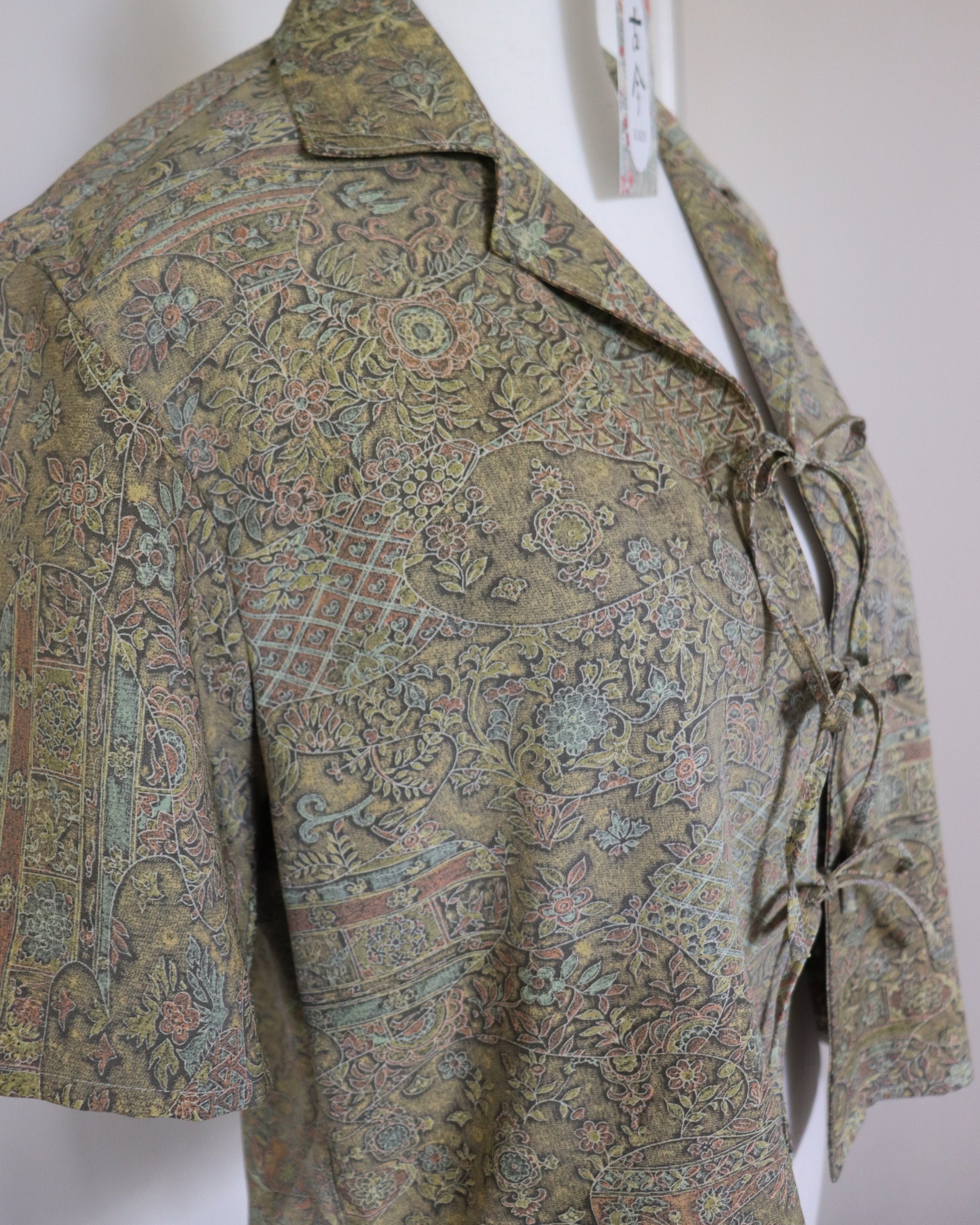 Patterned shirt on a mannequin against a plain background