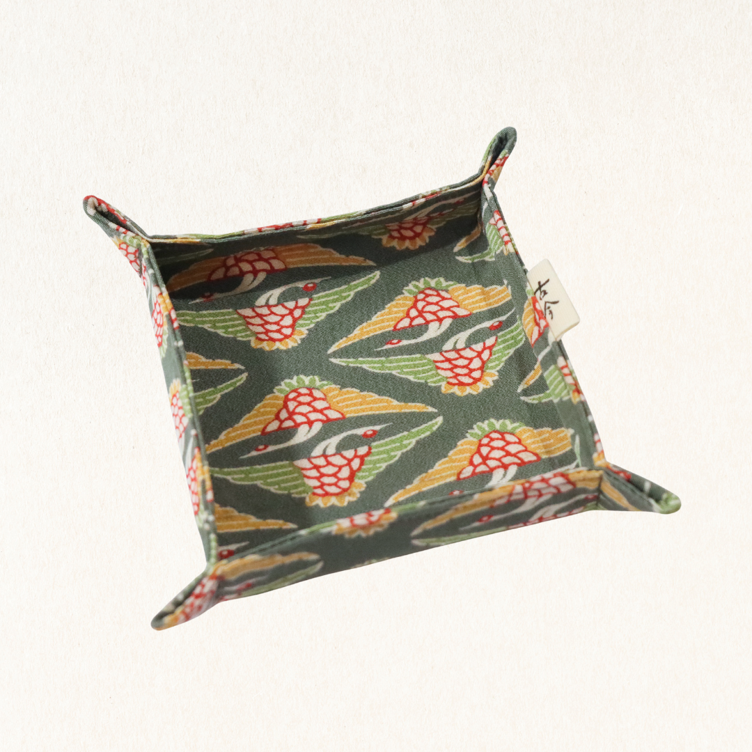 Fabric tray in green fabric with the pattern of cranes.