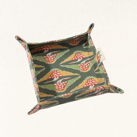 Fabric tray in green fabric with the pattern of cranes.