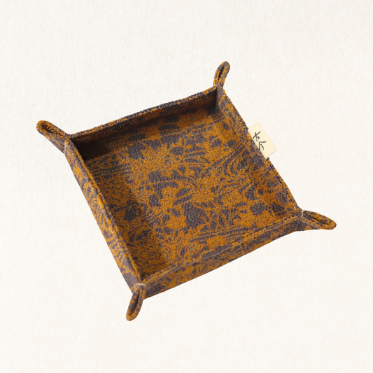 Fabric tray in gold and grey fabric.