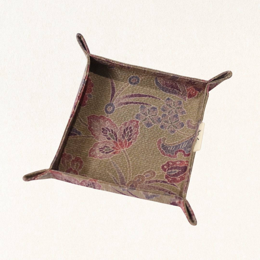 Fabric tray in brown fabric with floral pattern.