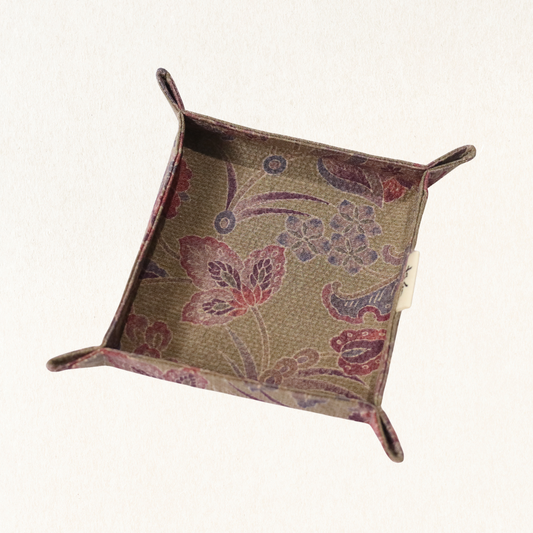 Fabric tray in brown fabric with floral pattern.
