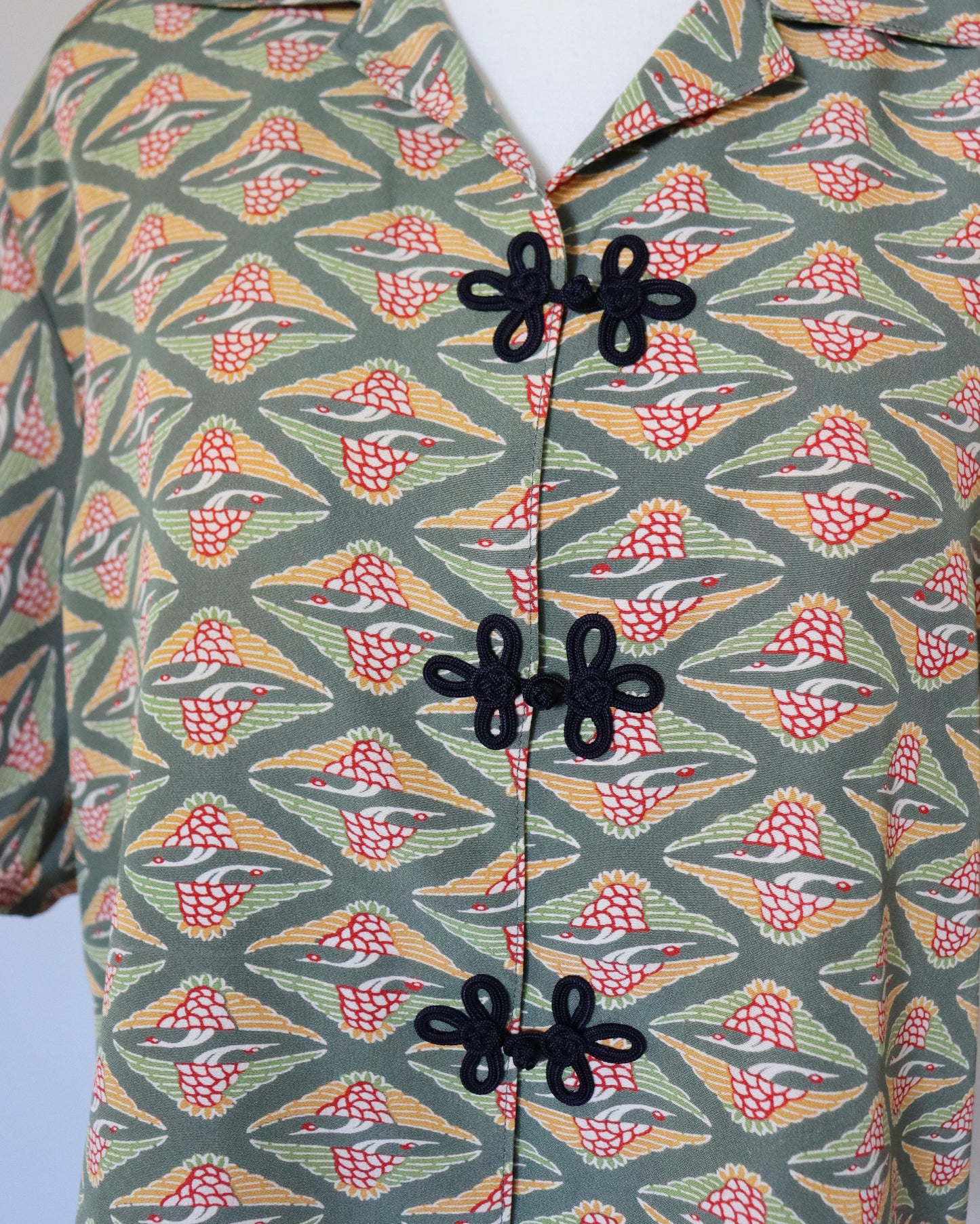 Patterned shirt with black buttons on a light blue background