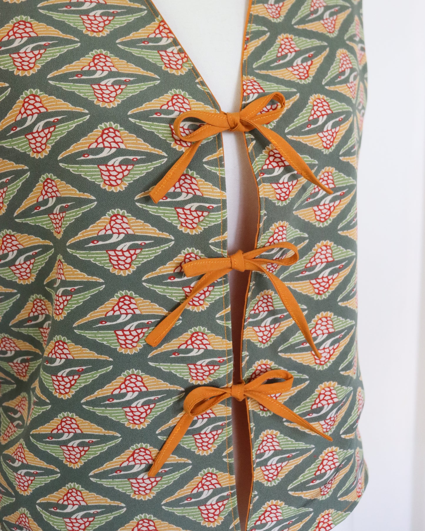 Patterned fabric with orange ribbon on a white background