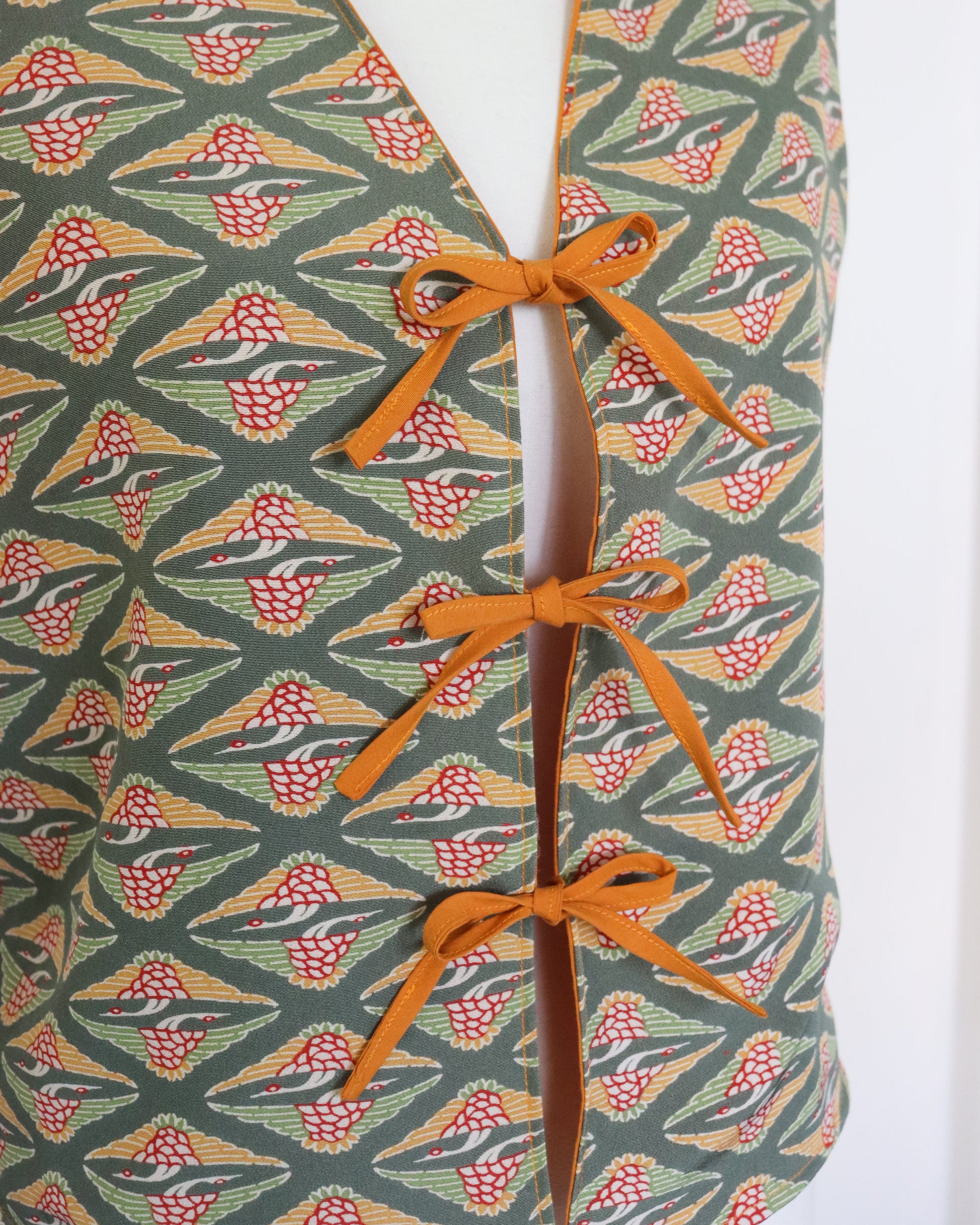 Patterned fabric with orange ribbon on a white background