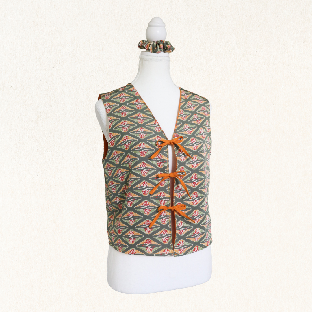 Patterned vest on a mannequin with a white background