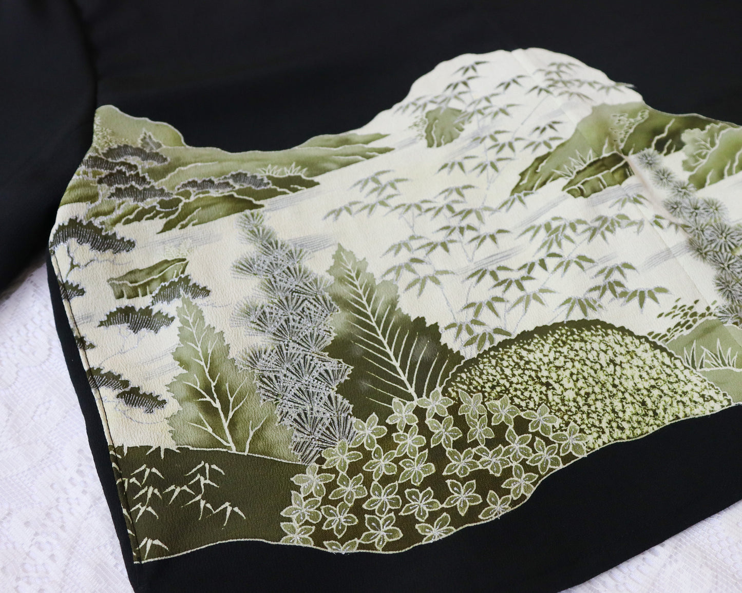 Textile with nature-themed design on a black background