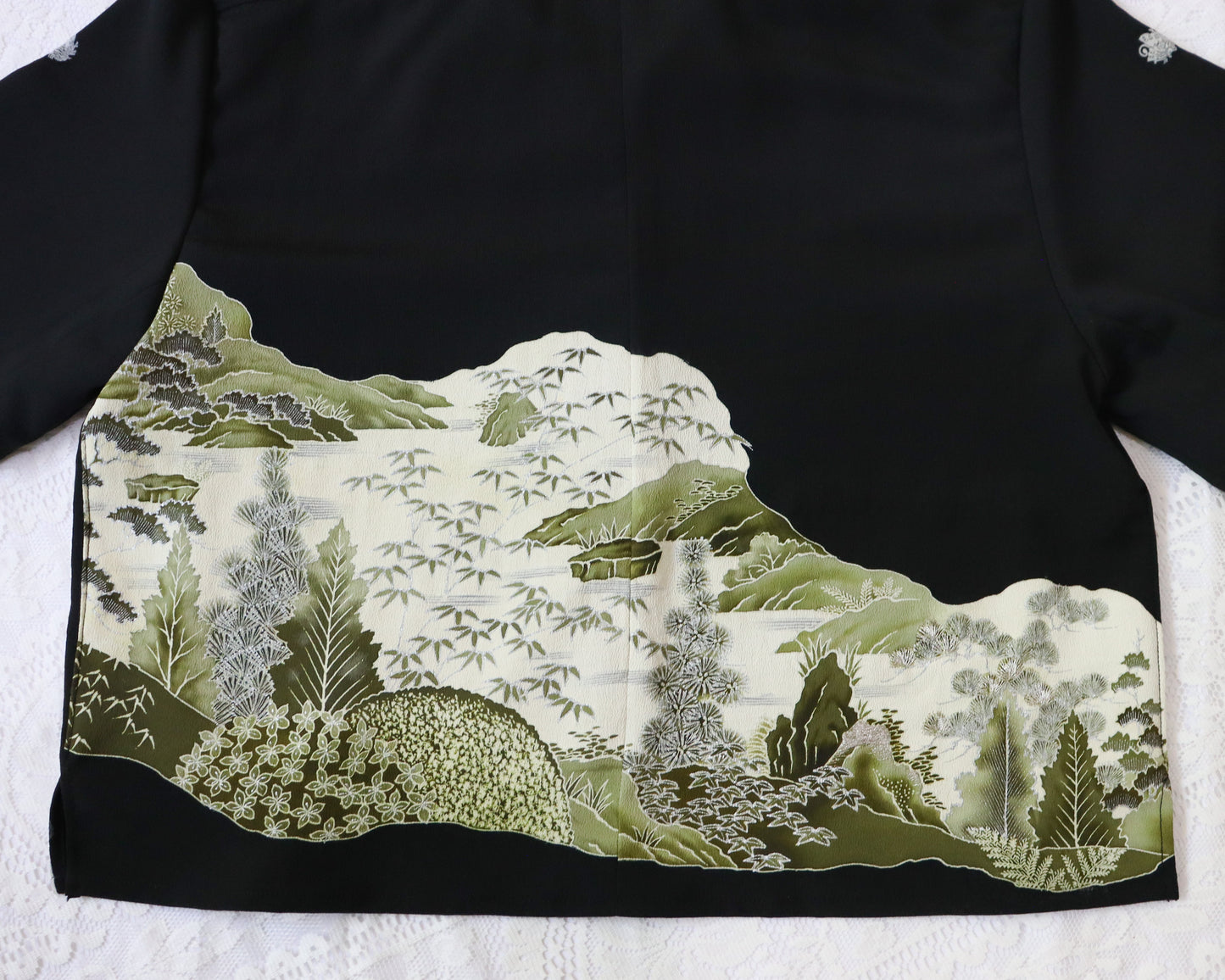 Traditional Japanese kimono with a landscape design on a black background
