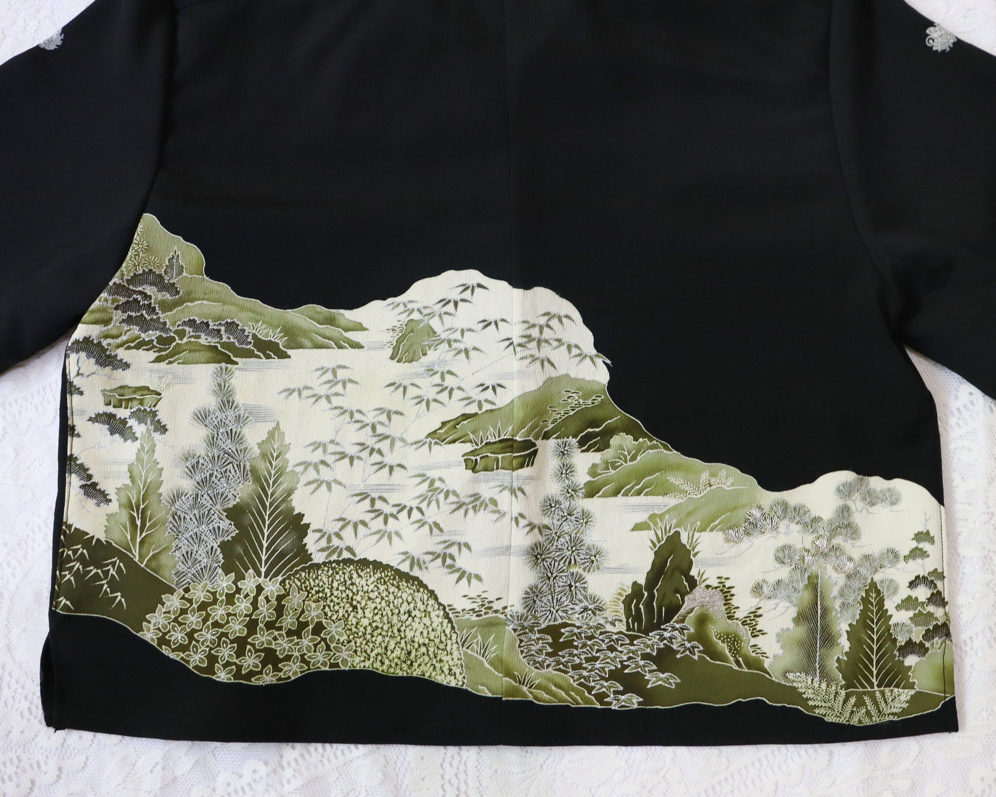 Traditional Japanese kimono with a landscape design on a black background