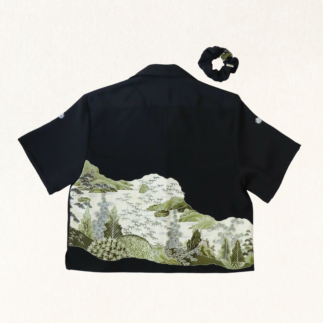 Black kimono with mountain landscape design and black scrunchie on white background