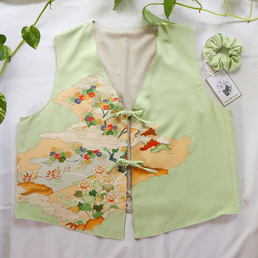 Light green vest with floral pattern on a white background