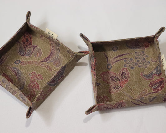 Fabric trays in brown fabric with floral pattern.